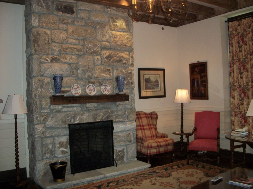 fieldstone fireplace with antique chair